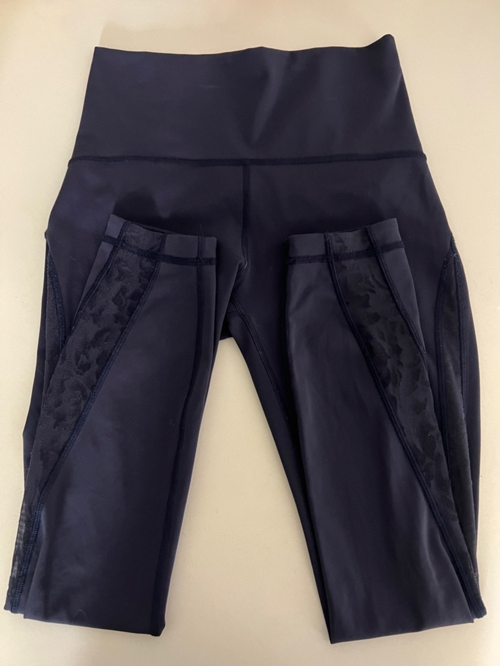 lululemon athletica navy blue workout leggings with subtle animal print panels.